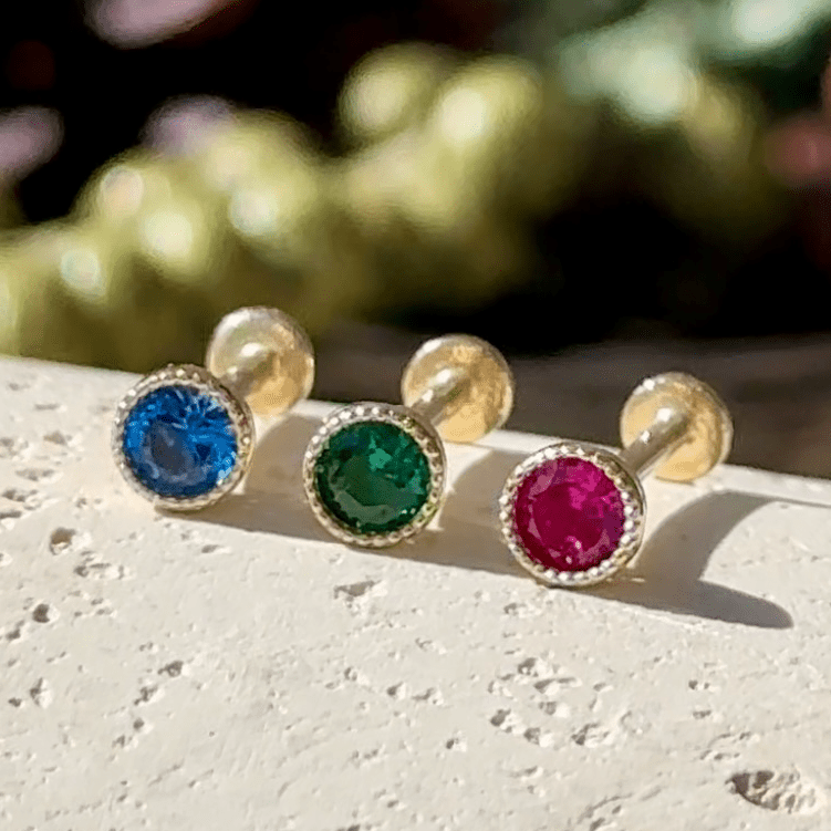 three different colored stones sitting on top of a white surface