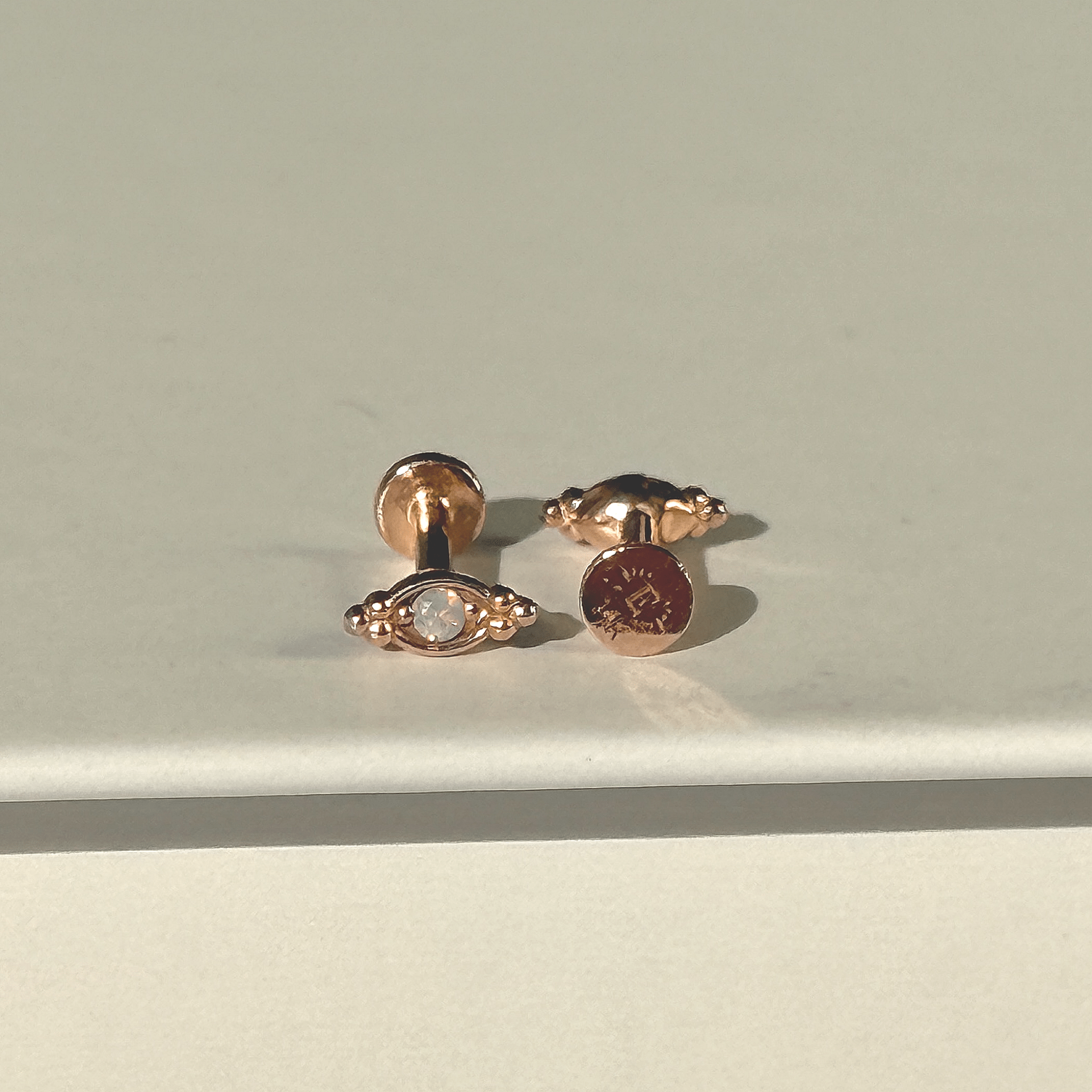 a pair of earrings sitting on top of a table