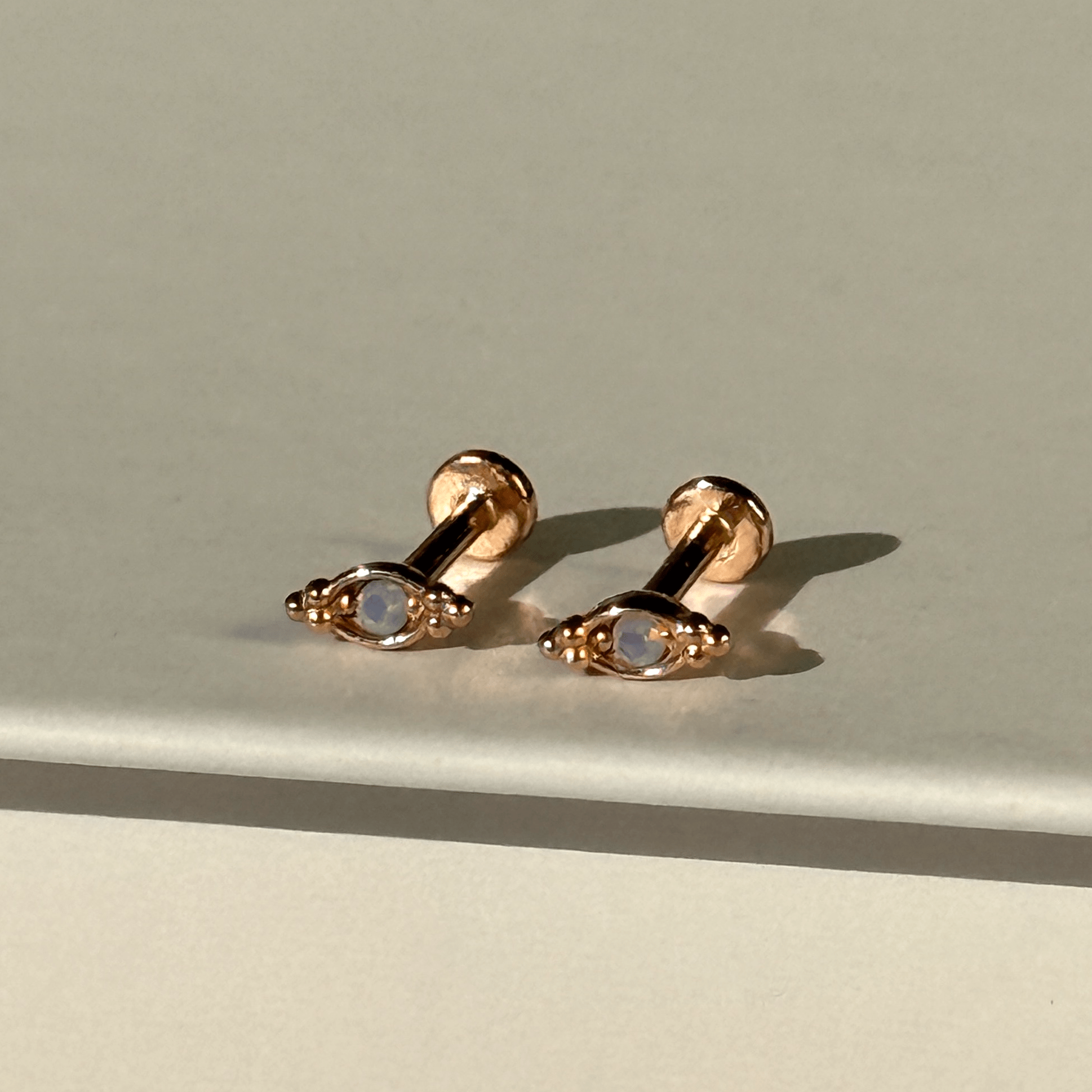 a pair of earrings sitting on top of a table