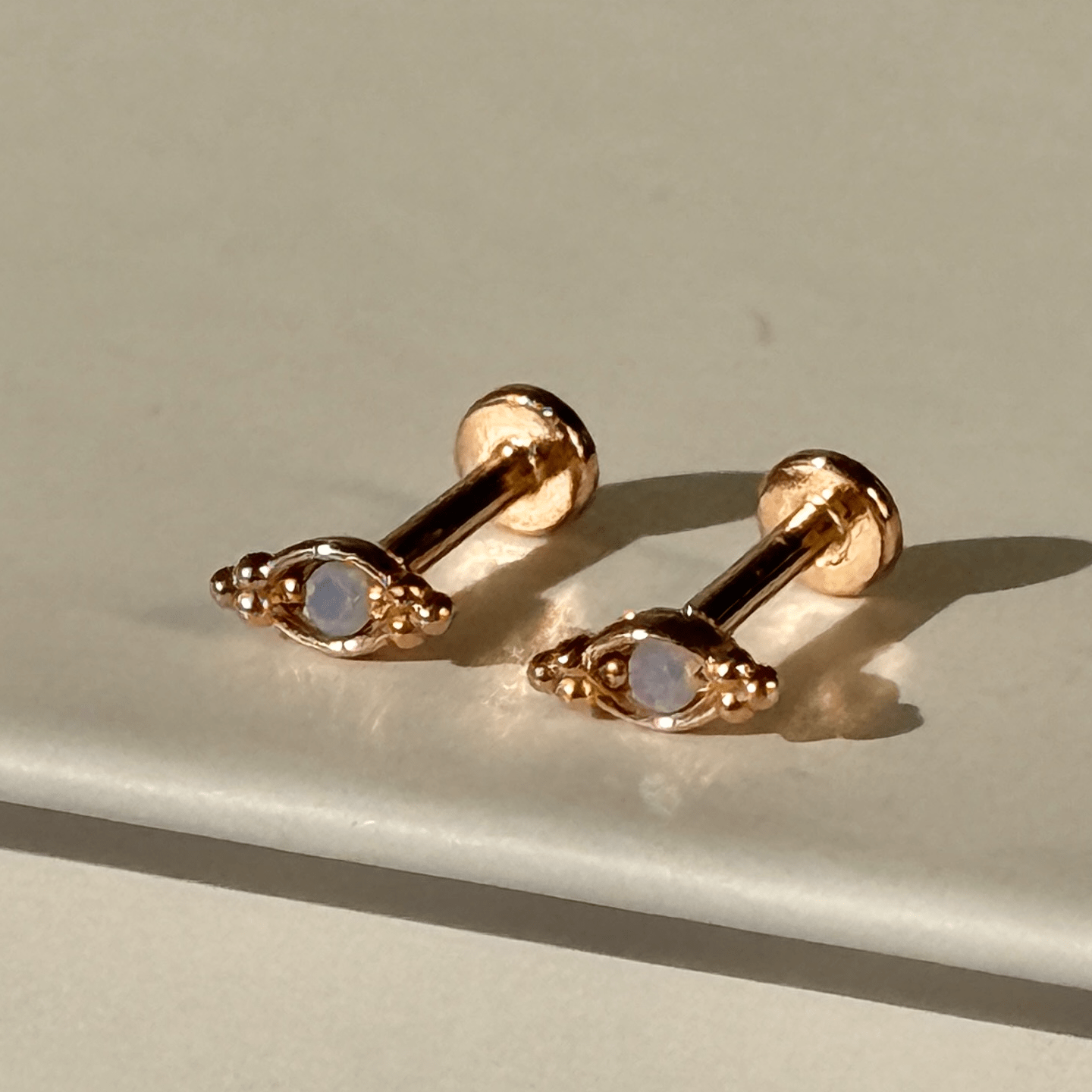 a pair of earrings sitting on top of a table