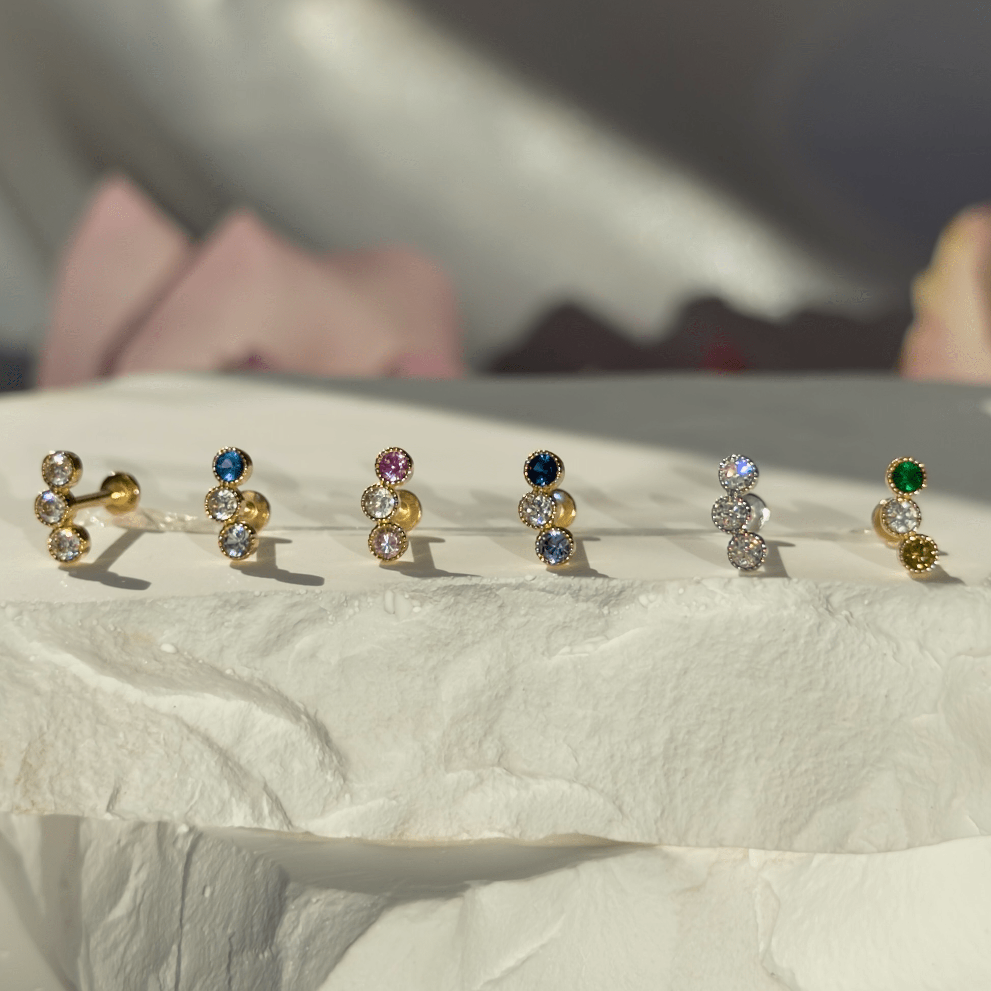 a row of different colored stones sitting on top of a white surface