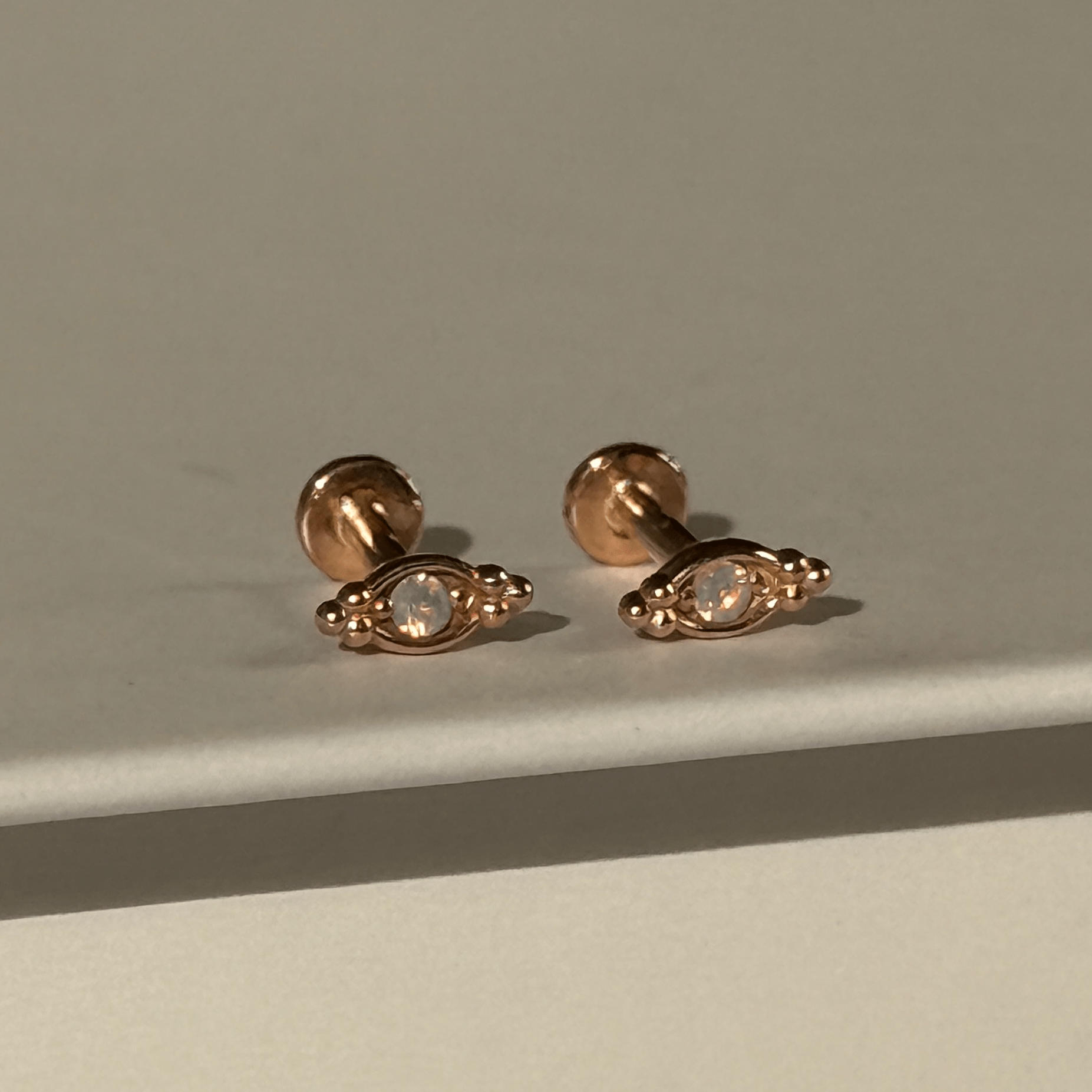 a pair of earrings sitting on top of a table