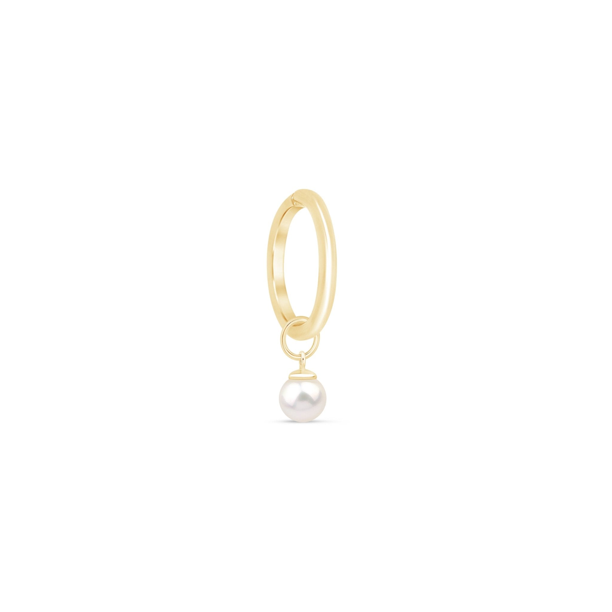 a gold hoop with a pearl hanging from it