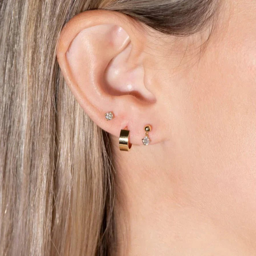 model wearing the diamond flat back stud along with other earrings