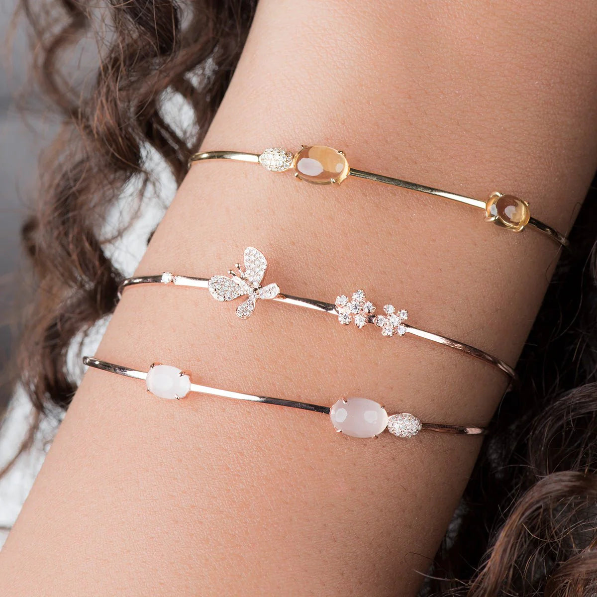 rose quartz diamond cluster cuff bandle stacked with other bangles